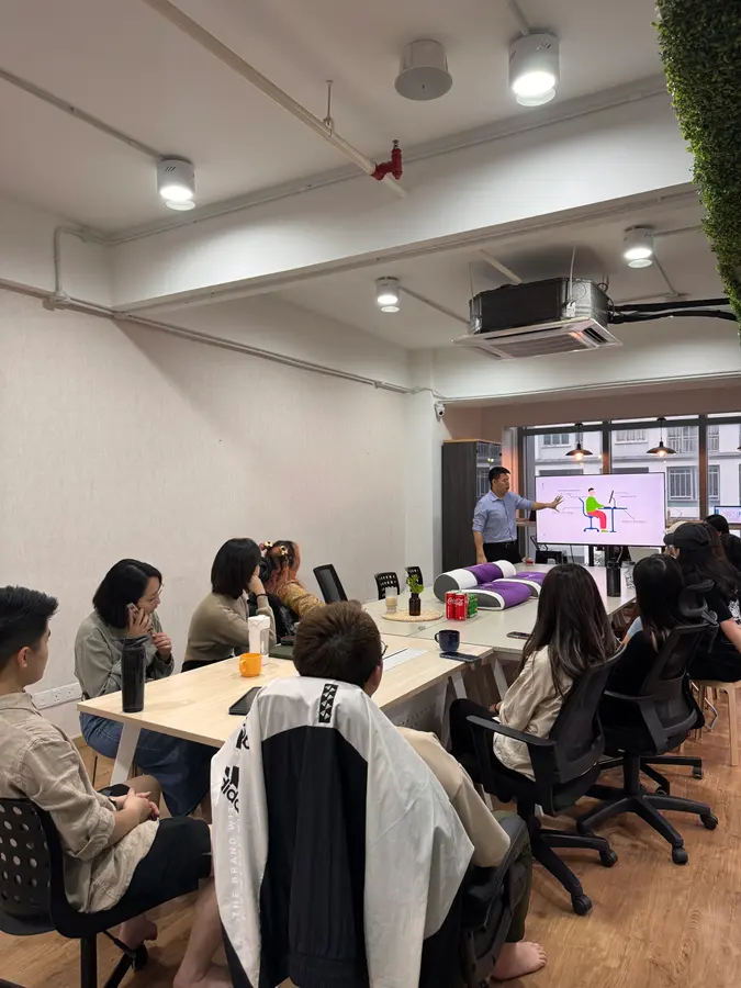 Chiropractor Kee Shan presenting an ergonomics talk for staff at Adstra Miles in Kuala Lumpur