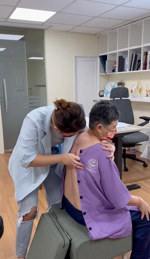 A Persistence chiropractor caring for a Ti-Ratana Welfare resident in Kuala Lumpur